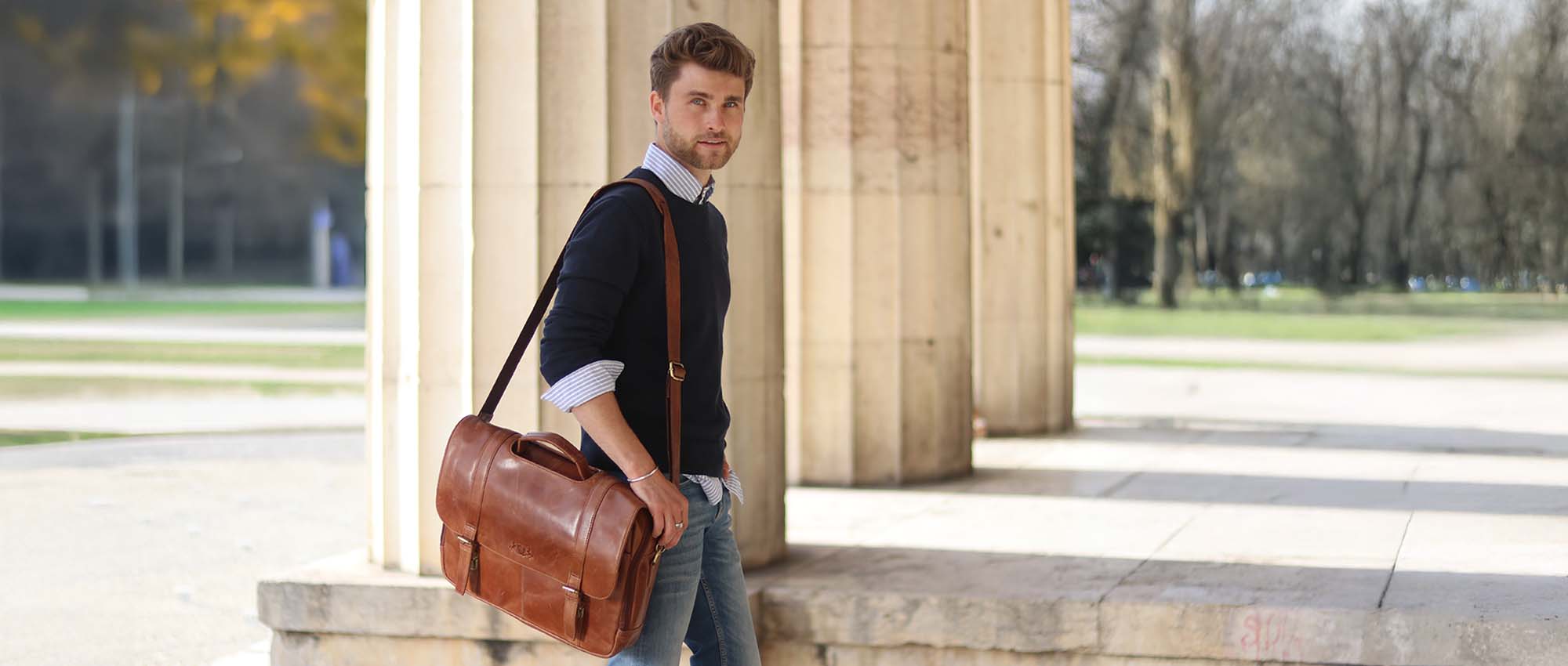 Bruine leren tas en man in een smart casual outfit