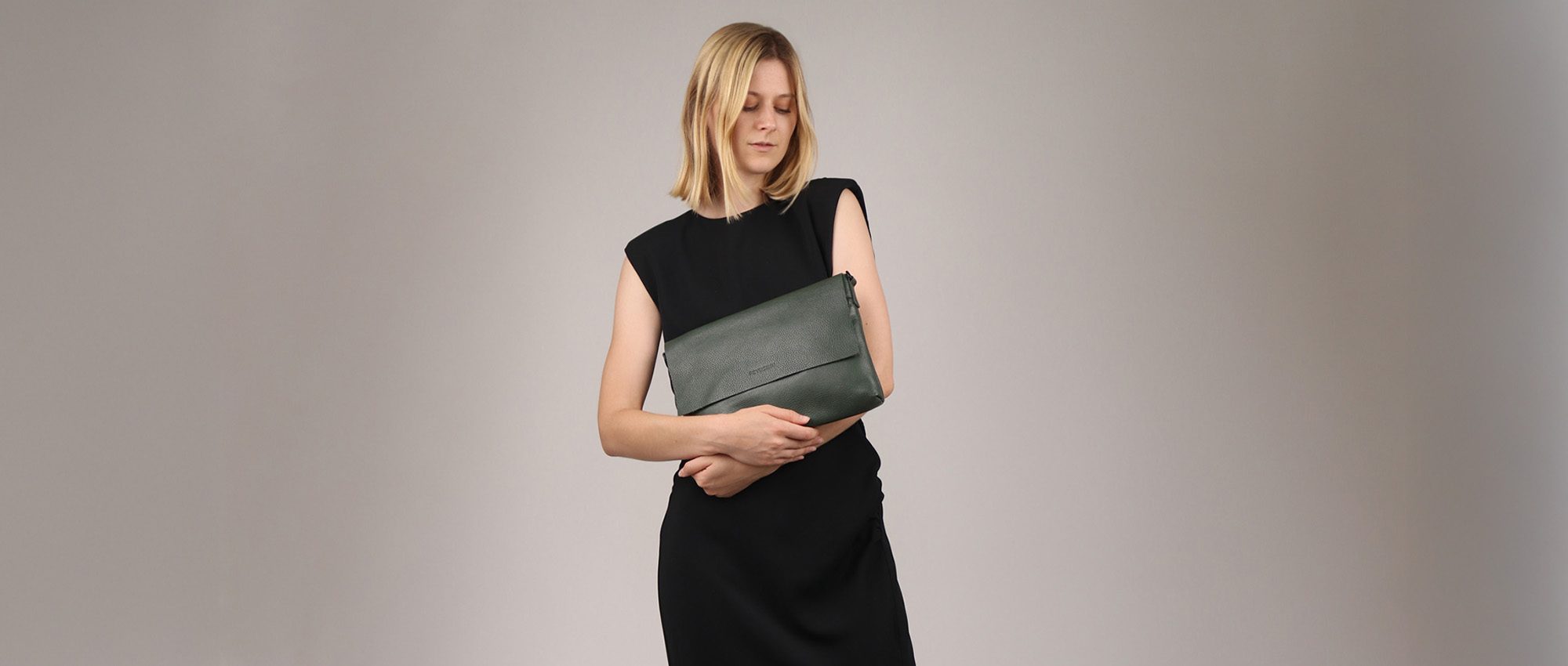 Leather clutch handbag in the hand of a blonde woman