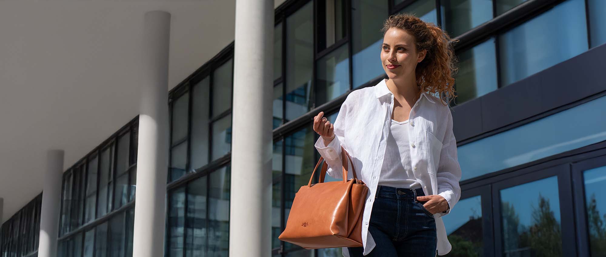 Brown leather handbag and a woman