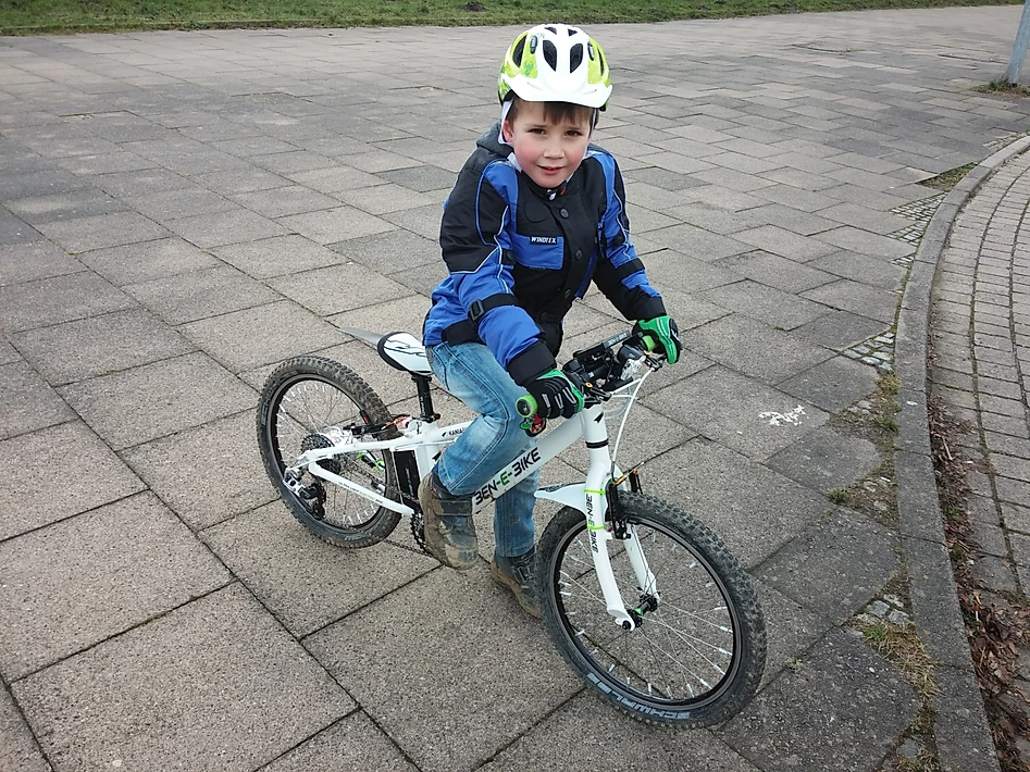 Ein Kind macht die erste Probefahrt des 20er E-Bikes