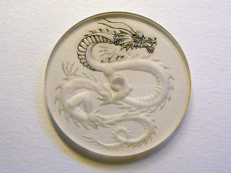 Engraved dragon is applied with a first layer of paint