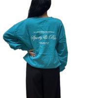 Sweat-shirt femme Sporty & Rich avec col rond, lettrage logo et imprimé dos turquoise Sweat-shirt femme Sporty & Rich avec col rond, lettrage logo et imprimé dos turquoise
