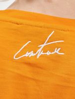 Le haut court Couture Club avec un imprimé gothique superposé en orange Le haut court Couture Club avec un imprimé gothique superposé en orange