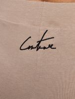 The Couture Club cycling shorts with graphic label and detail in beige