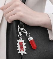 Stylish Calvin Klein Downtown Charm Set - Stainless Steel Pendants with Contrasting Resin and "MORE" Logo - Bag Accessories - 7 x 1.3 cm - KJJCRA090100 - Silver/Red