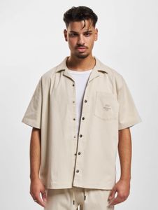Polo elástico informal DEF para hombre, de algodón, color beige.