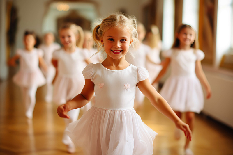 Lächelnde, kleine Ballerina in Ihrer Tanzgruppe