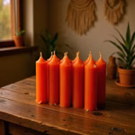 Close-up-lifestyle-shot-of-vintage-orange-taper-candles-displayed-on-a-weathered-wooden-table--arranged-in-a-row-with-varying-heights--some-partially-burned-down-to-create-a-rustic-effect.jpg