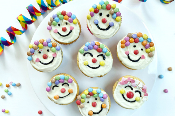 Mehrere Muffins, die wie Clowns geschmückt sind.