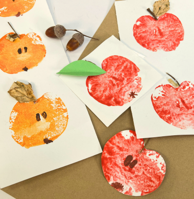 Apfeldrucke. Eine Apfel halbieren und mit Farbe bestreichen. Jetzt auf Papier drucken und bemalen und verzieren.