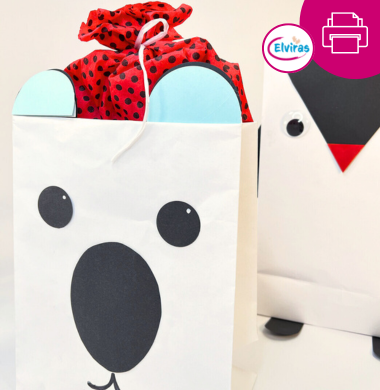 Große weiße Papiertüten, die mit bunten Fotokarton zu Tieren verziert wurden: einem Eisbären und einen Pinguin. Dazu bietene wir kostenlose Bastelvorlagen.