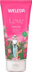 Die rosa 200ml Tube der Weleda Love Shower Cream Rose zeigt eine Frau mit Hut und Rosenkorb in einem Garten. Das Etikett hebt "Verwöhnende Rose" Naturkosmetik und 100% natürliche Herkunft der Marke Weleda hervor.