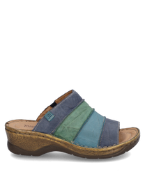 The clog is made of leather and features a multicolored design in shades of blue and green. It has a comfortable elastic closure and a sturdybrown textured sole that provides optimal grip.