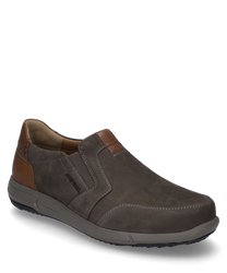 The slipper is made of dark brown leather with a beige elastic band. It features a contrasting light brown heel area and distinctive white decorative stitching.