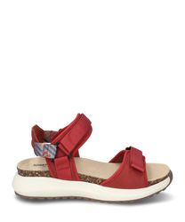 Red sandal with Velcro closuremade from durable material. The sole is white and ergonomically shapedfeaturing a comfortable footbed and a patterned heel strap for added support.