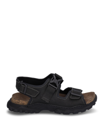 The sandal is made of black leather with striking white stitching. It features a buckle closure and a sturdyprofiled sole for optimal grip.