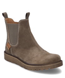 The ankle boot made of brown suede features an elastic rubber band for easy on and off. It is characterized by a sturdyribbed sole and subtle decorative stitching.