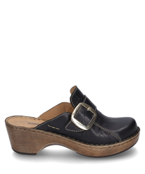 This black leather clog features a large buckle as a closure. The shoe has a sturdy wooden sole with a visible light brown seam giving the design a rustic charm.