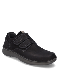 The half shoe made of black leather features a practical Velcro closure for easy on and off. The contrasting stitching and the sturdy gray sole give it an elegant yet sporty appearance.