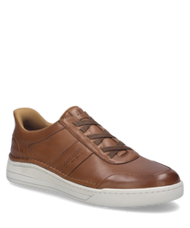 La sneaker de couleur châtaigne est en cuir lisse et dispose d'un élastique pratique comme fermeture. La semelle blanche offre un accent contrasté par rapport à la tige marron.