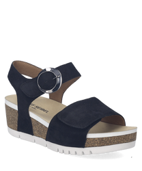 Sandalo nero con chiusura in velcro e fibbia rotonda. Suola in sughero con piattaforma bianca per un look casual e moderno.