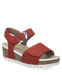 These sandals feature a red suede material with a Velcro closure for easy adjustment. The design includes a wedge cork sole for added height and comfort.