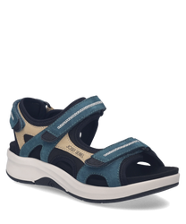 Die Sandale aus Leder zeigt sich in Blau und Beige. Sie verfügt über Klettverschlüsse für eine individuelle Passform.