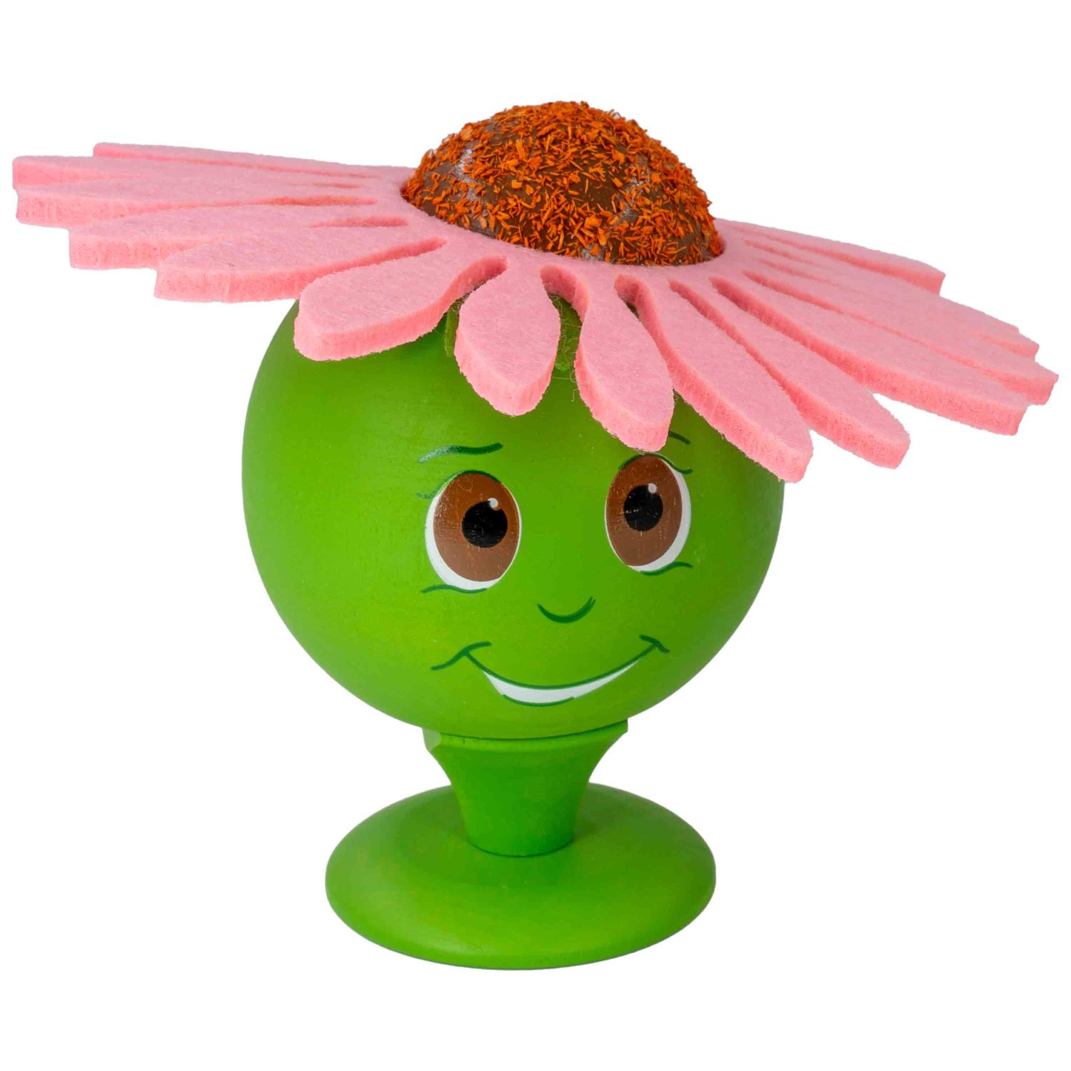 Eine grüne Räucherblume mit pinkem Blumenhut und lächelndem Gesicht steht auf grünem Sockel