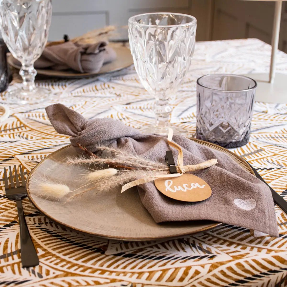 Gedeckter Tisch mit Geschirr und verschiedenen Gläsern