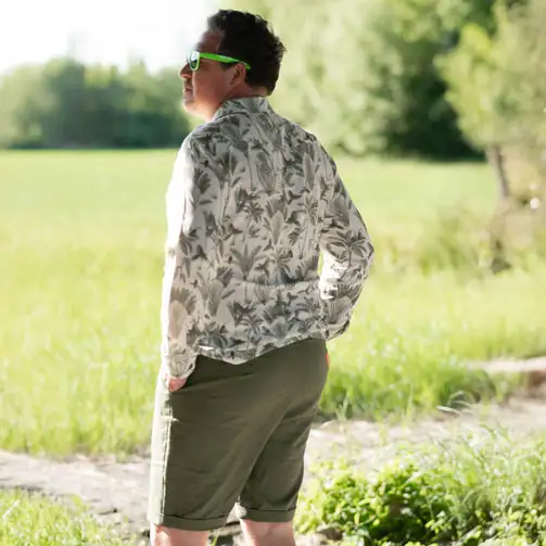 Mann mit hellem Viskose Stoff mit grünen Palmen