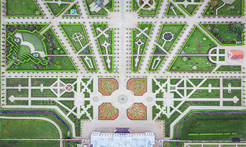 Aerial view of the majestic garden of Rundāle Palace, distinguished by its impressively symmetrical design.