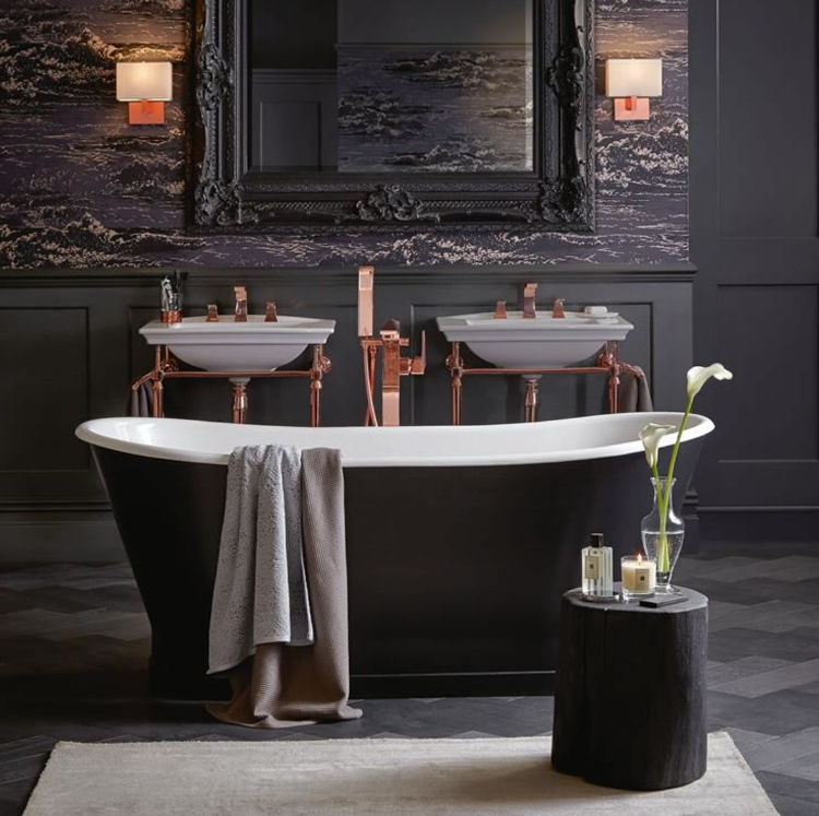 You see a beautiful hotel bathroom with a freestanding bathtub by Casa Padrino in the color black and white