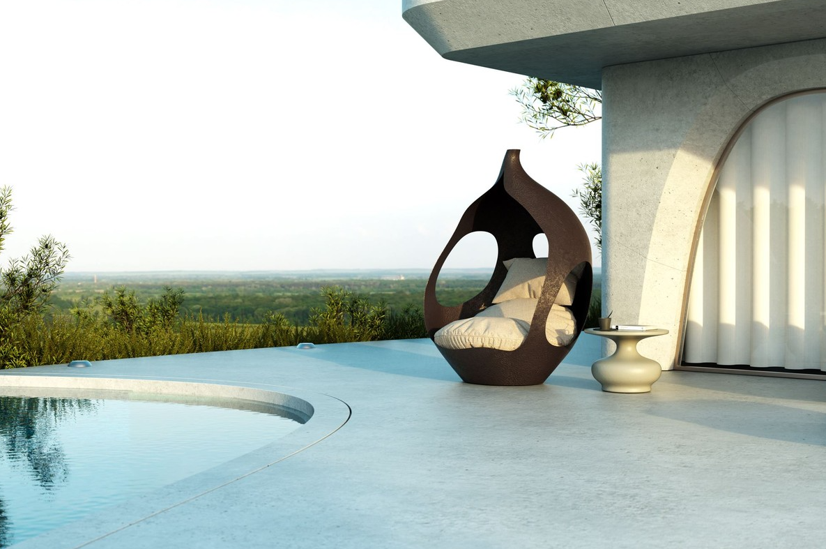 Designer furniture in drop shape as a sun lounger by a pool