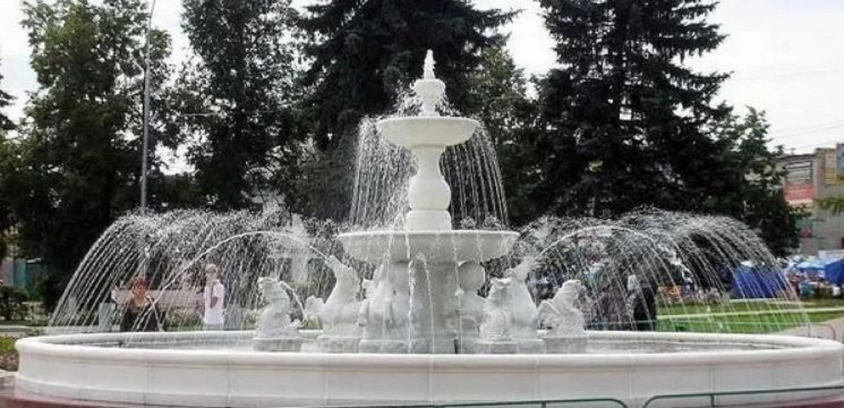 You see a very large fountain with a white border on two floors.