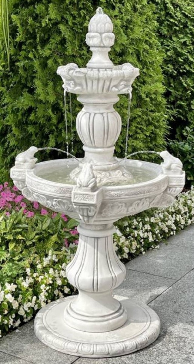 You see a small terrace fountain with two levels in a magnificent design and frogs as gargoyles.