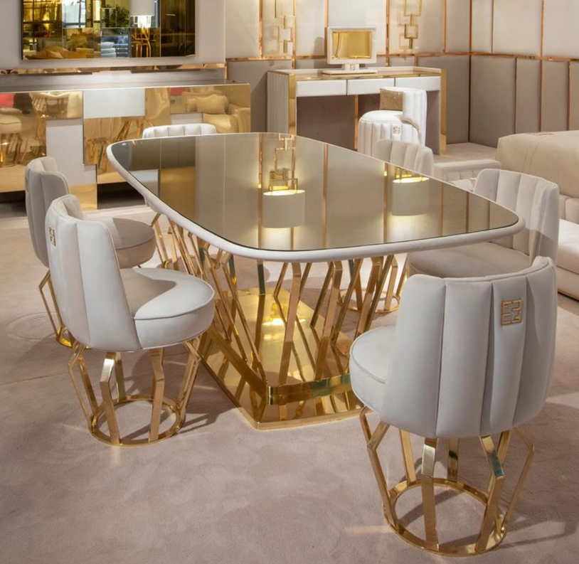 Luxurious dining table in gold with white chairs by Casa Padrino.